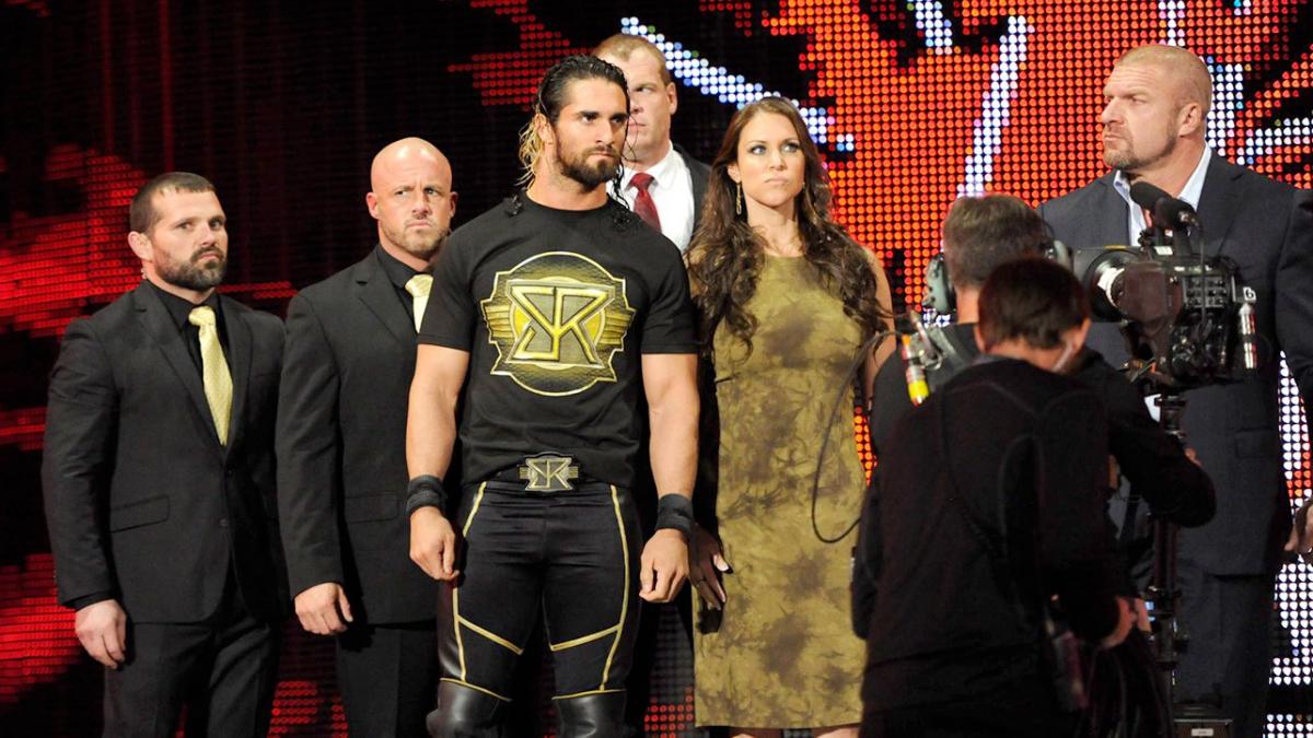 Seth Rollins with the Authority: J&J Security, Kane, Stephanie McMahon, and Triple H